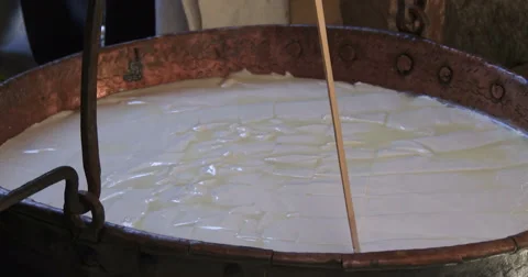 Cheesemaking of Mountain Cheese in a log cabin. Video stock 69071446