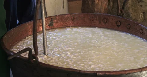 Cheesemaking of Mountain Cheese in a log cabin. Stock Footage 69147933