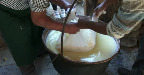 Cheesemaking of Mountain Cheese in a log cabin. Video stock 69150033