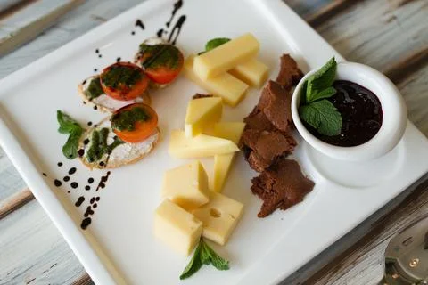 Cheeseplate with souce on a table Stock Photos