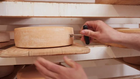 Cheesmonger hands sampling the cheese - traditional cheesmaking Video stock 154386287