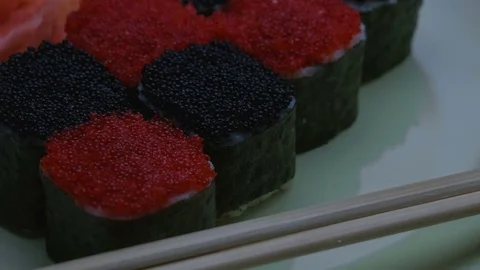 "Cheess" square sushi rolls with salmon, cucumber, cream cheese, red and black Stock Footage 75033441