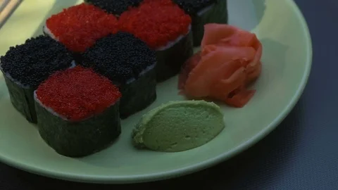 "Cheess" square sushi rolls with salmon, cucumber, cream cheese, red and black Stock Footage 75033734