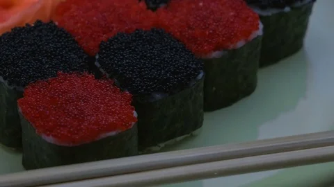 "Cheess" square sushi rolls with salmon, cucumber, cream cheese, red and black Stock-Footage 75174854
