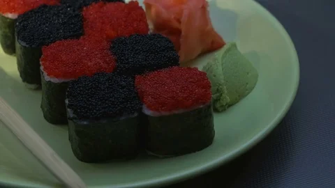 "Cheess" square sushi rolls with salmon, cucumber, cream cheese, red and black Stock Footage 75175726
