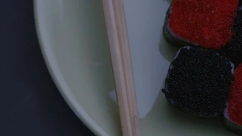 "Cheess" square sushi rolls with salmon, cucumber, cream cheese, red and black Stock-Footage 75181989