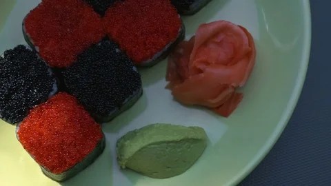 "Cheess" square sushi rolls with salmon, cucumber, cream cheese, red and black Stock Footage 75182752