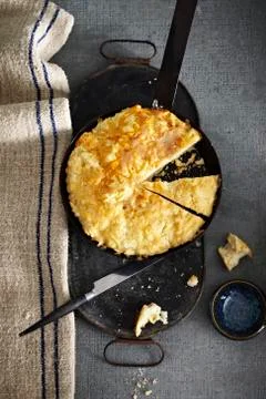 Cheesy Bannock bread in baking pan on grey background, studio shot Stock Photos