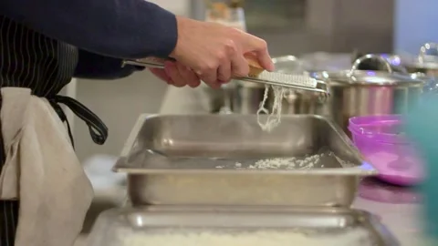 Cheesy Creations: The Master Chef Grating Cheese Stock Footage 247153117