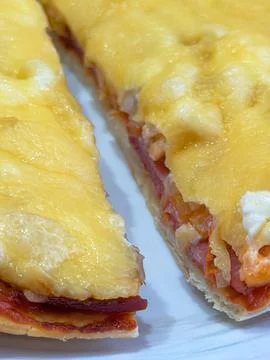 Cheesy pizza slice pull from board Stock Photos