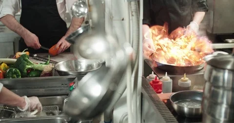 Chef actively working in the kitchen of the restaurant with Asian cuisine Stock Footage 84686391