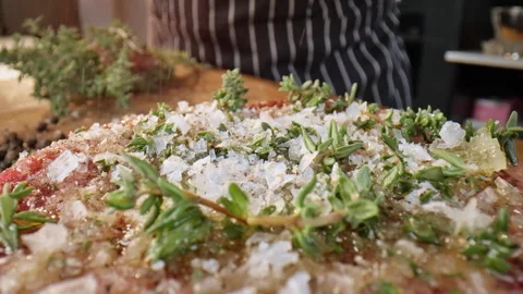Chef add pepper and spices to the steak. Food preparation. Slow motion 50fps. Stock Footage 305386763