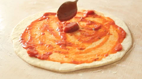 A chef add tomato sauce to an almost finished pizza in a restaurant Stock Footage 65521293