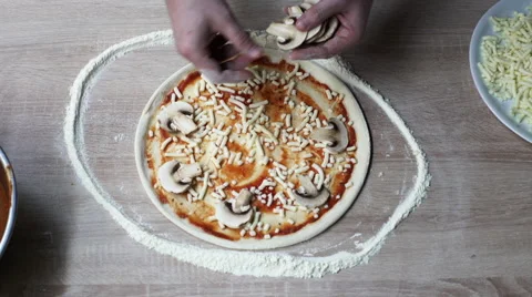 Chef adding champignons on pizza dough Stock Footage 61413972