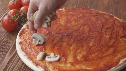 Chef adding champignons on pizza dough Stock Footage 69196938