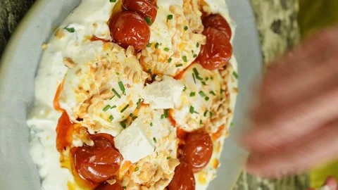 The chef adding cheese to a delicious poached eggs. Vertical video. Stock Footage 311046153