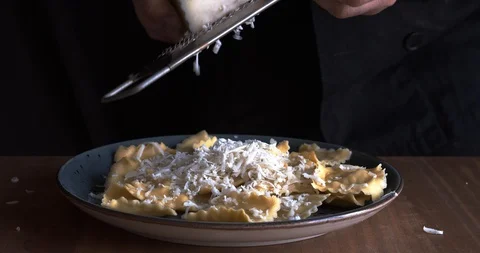 Chef adding cheese to ravioli Stock Footage 128504364