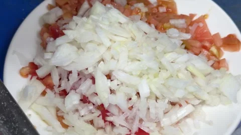 Chef adding chopped onions to a tomato salad 動画素材 344100072