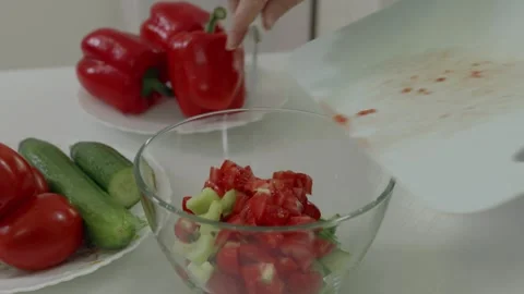 Chef adding chopped tomatoes to fresh vegetable salad Stock Footage 321041683