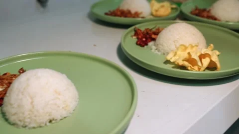 Chef Adding Crackers to Nasi Lemak Plates in Kitchen Line Stock Footage 342219669