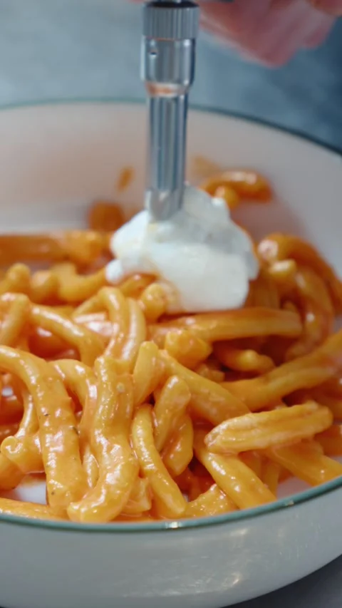 Chef Adding Cream Foam to Fresh Pasta Using Culinary Siphon Stock Footage 341404211