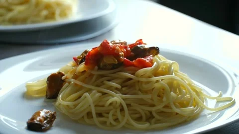 Chef adding delicious mussel sauce to spaghetti pasta Stock Footage 337891701