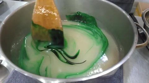Chef Adding Drops of Food Coloring into Large Pot of Boiling Sugar Syrup Stock-Footage 345292010
