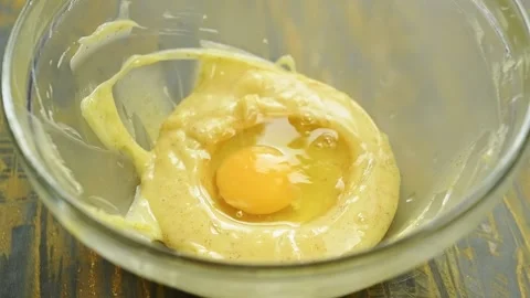 The chef adding an egg into the bowl of brown butter. Stock Footage 233572447