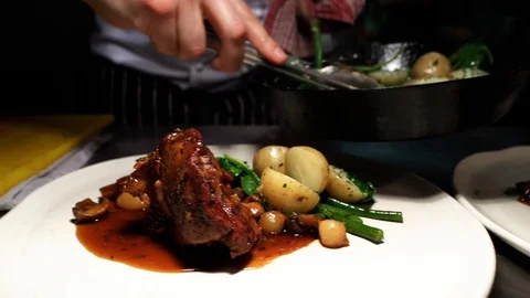 Chef adding the finishing touches to a delicious looking meal Stock Footage 106809849