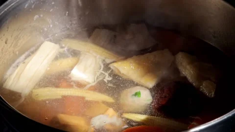 Chef adding fish tofu to Homemade Sukiyaki or Shabu boiling in pot  Stock-Footage 159004250