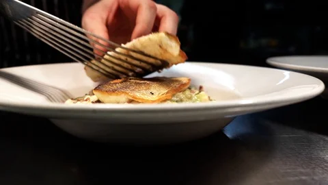 Chef adding food onto a steamy plate Stock Footage 106809868