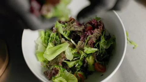Chef Adding Fresh Lettuce Leaves to Salad Bowl Stock Footage 312813744