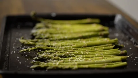 Chef adding freshly cracked pepper to fresh asparagus Stock Footage 116787277