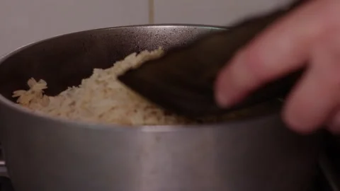 Chef adding ingredients to cooking pot with soup on stove 스톡 동영상 342387438
