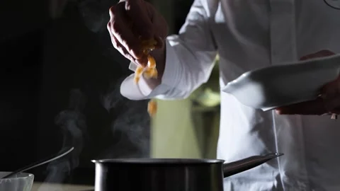 Chef Adding Ingredients to Steaming Pot: Gourmet Cooking Video stock 304033977