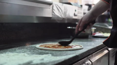 Chef adding ingredients: tomato, cheese and bacon on pizza dough Stock Footage 61414113