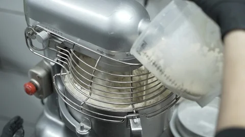 Chef adding liquid to mixing machine in restaurant kitchen. Close up slow Stock Footage 115539565