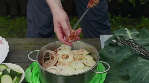 Chef adding marinated meat on skewer outdoors Stock Footage 296692144