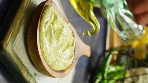 The chef adding olive oil to a delicious whipped feta. Vertical video. 스톡 동영상 333708415