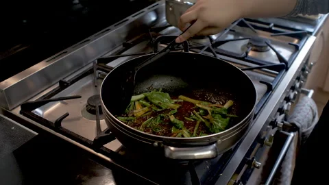 Chef Adding Pak Choi Into Wok And Stirring It In With Chilli Paste. Locked Stock Footage 220272269
