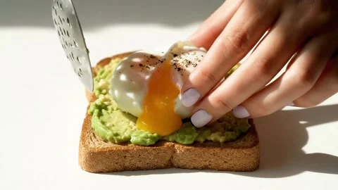 Chef Adding Poached Egg to Avocado Toast Stock Footage 314805406