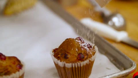 Chef is adding powder to muffins Stock Footage 138457123