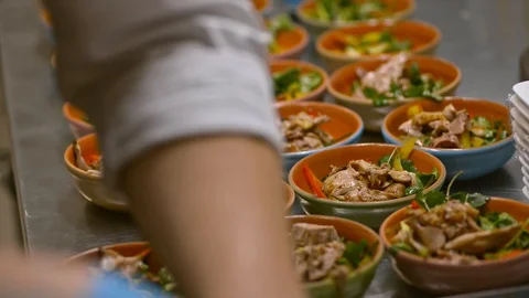 Chef adding putting meat in salad plates, finishing the meal lrrl. serving food Stock Footage 128283708