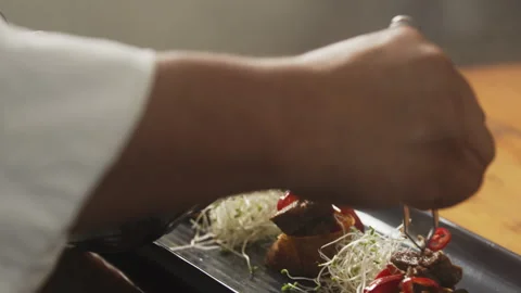 Chef adding red pepper to his dish Stock Footage 274668540