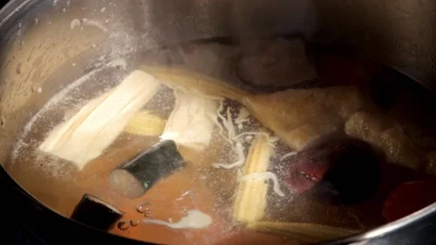 Chef adding seaweed meatball to Homemade Sukiyaki or Shabu boiling in pot  Video stock 159004253