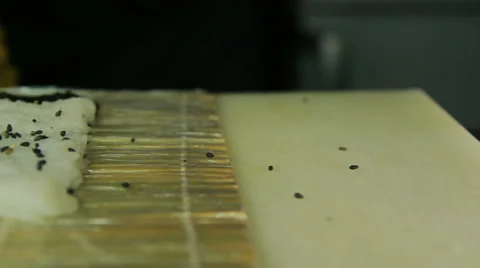 Chef adding sesame to sushi rolls Stock Footage 41952888