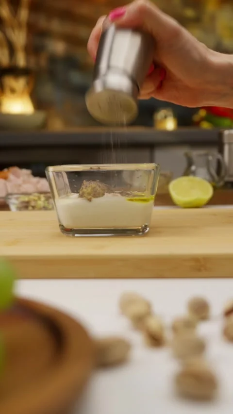 Chef adding spices to yogurt dip with mustard and olive oil Stock Footage 310928582