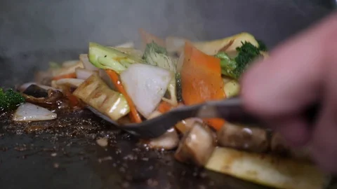 Chef Adding Steak To Japanese Hibachi Grill With Other Food Cooking On It. Video stock 99692147