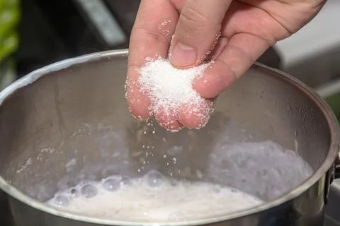 Chef adding sugar in the milk 스톡 사진