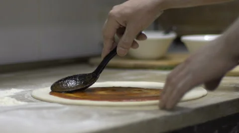 Chef adding tomato sauce on pizza dough. Slow motion Stock Footage 61896360